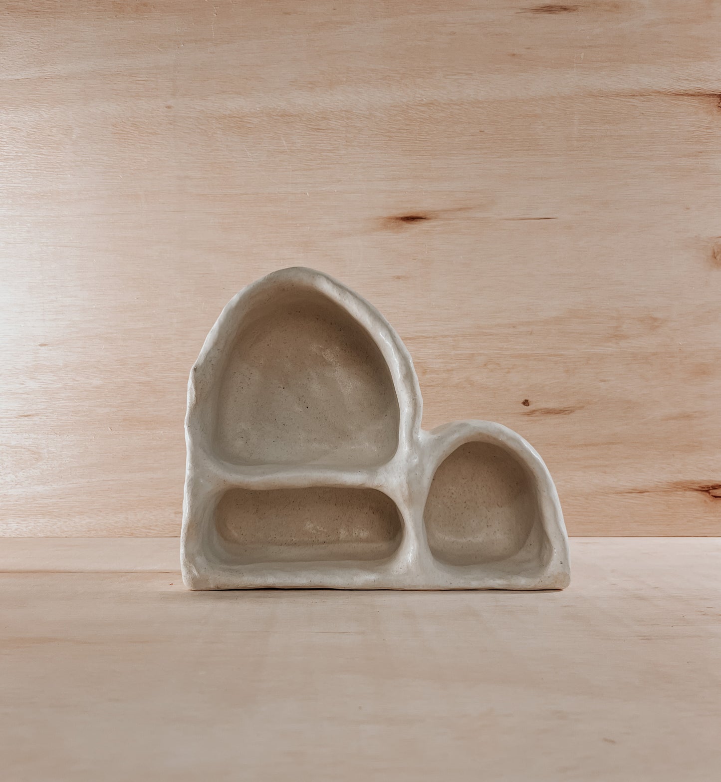 Hand-built ceramic altar with matte glaze, wall-mounted, soft curves, handmade in Boulder