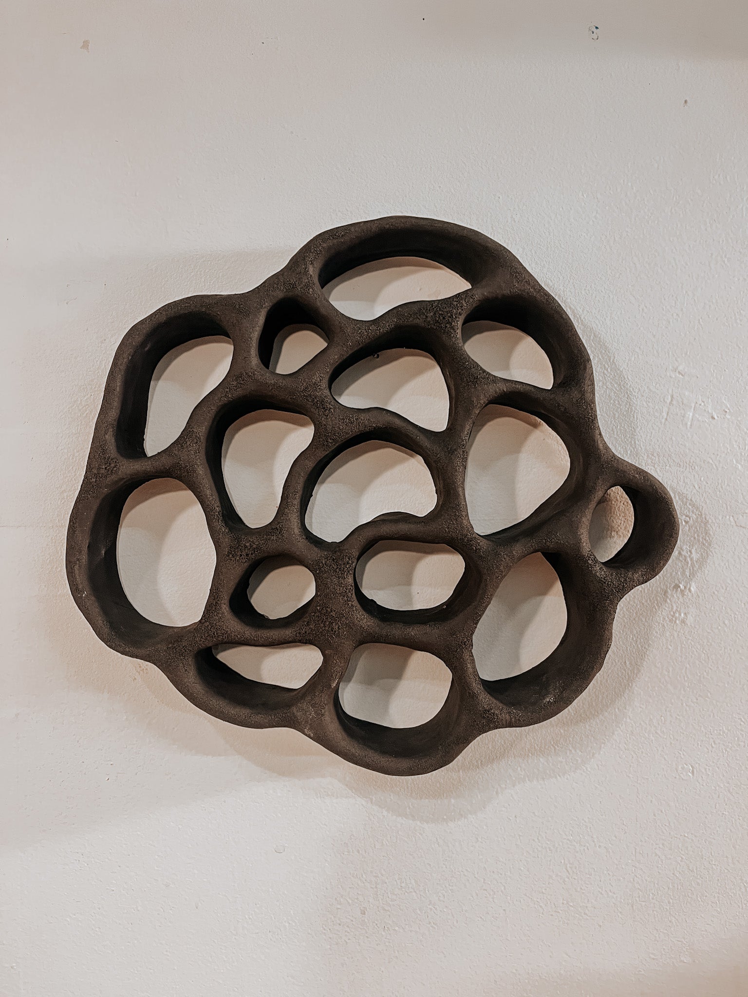 Hand-built ceramic altar with matte glaze, wall-mounted, soft curves, handmade in Boulder