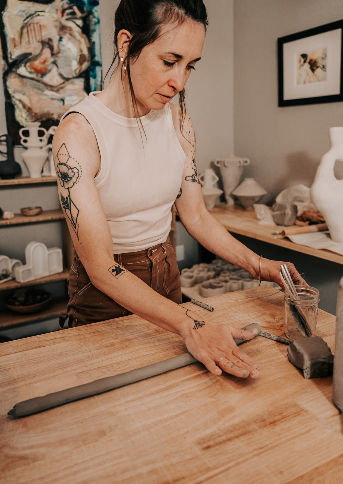 Student hand-building a ceramic altar in pottery class at Boulder art studio